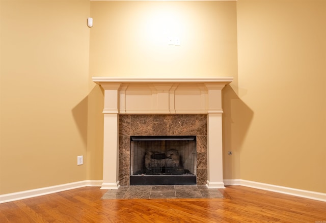 interior details featuring hardwood / wood-style floors and a fireplace