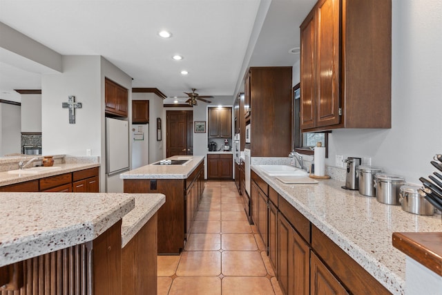 kitchen featuring black electric stovetop, crown molding, light tile patterned flooring, and sink