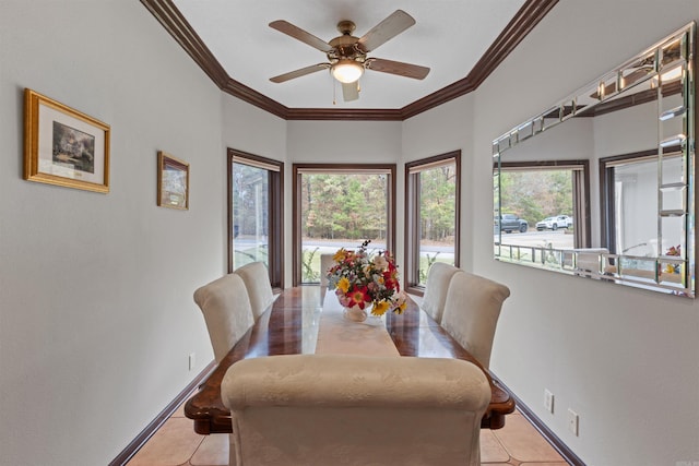 tiled dining space with ornamental molding and ceiling fan