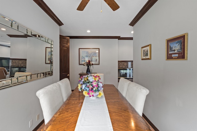 dining space with hardwood / wood-style flooring, ceiling fan, and crown molding