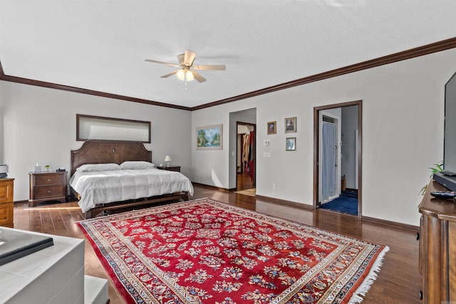 bedroom featuring a spacious closet, ceiling fan, ornamental molding, and dark hardwood / wood-style floors