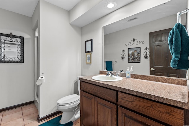 bathroom featuring vanity, toilet, a shower, and tile patterned flooring