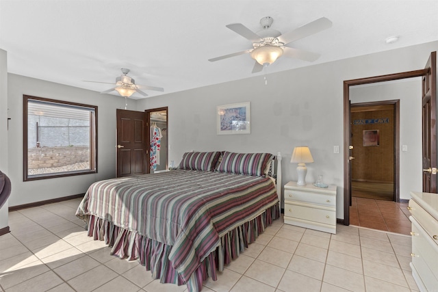 tiled bedroom featuring ceiling fan