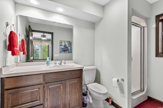 bathroom with tile patterned floors, toilet, a shower with shower door, vanity, and ceiling fan