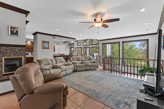 tiled living room featuring ceiling fan and crown molding