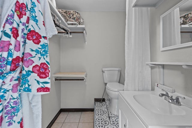 bathroom featuring vanity, toilet, and tile patterned flooring