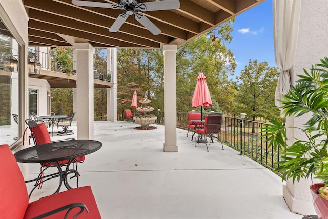 view of patio featuring ceiling fan and a balcony