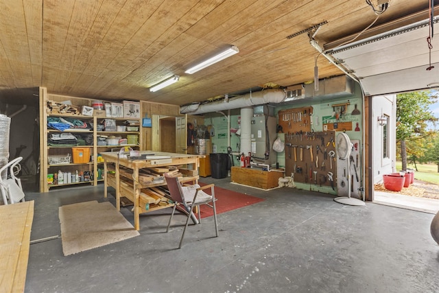 basement with wooden ceiling, a workshop area, and heating unit