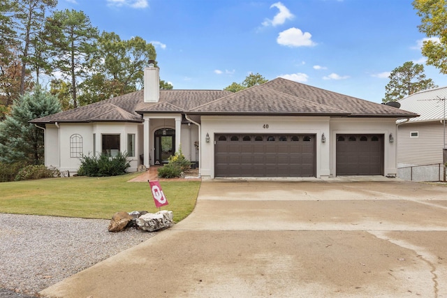 view of front of home featuring a front yard and a garage