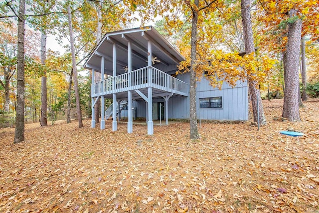 rear view of house featuring a wooden deck