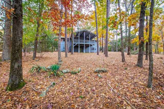 exterior space with a wooden deck and a sunroom