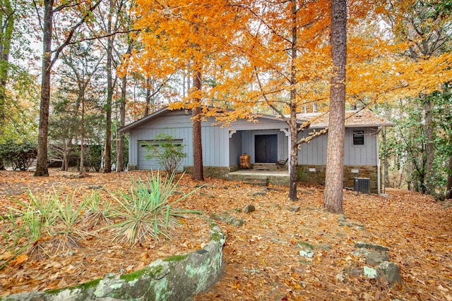 view of front of home with a garage and central air condition unit