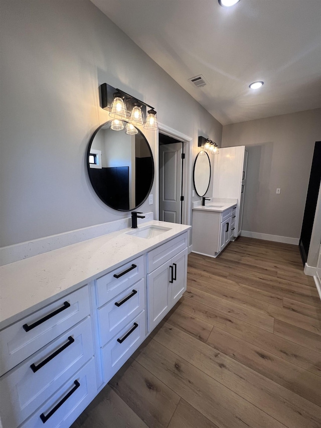 bathroom with hardwood / wood-style flooring and vanity