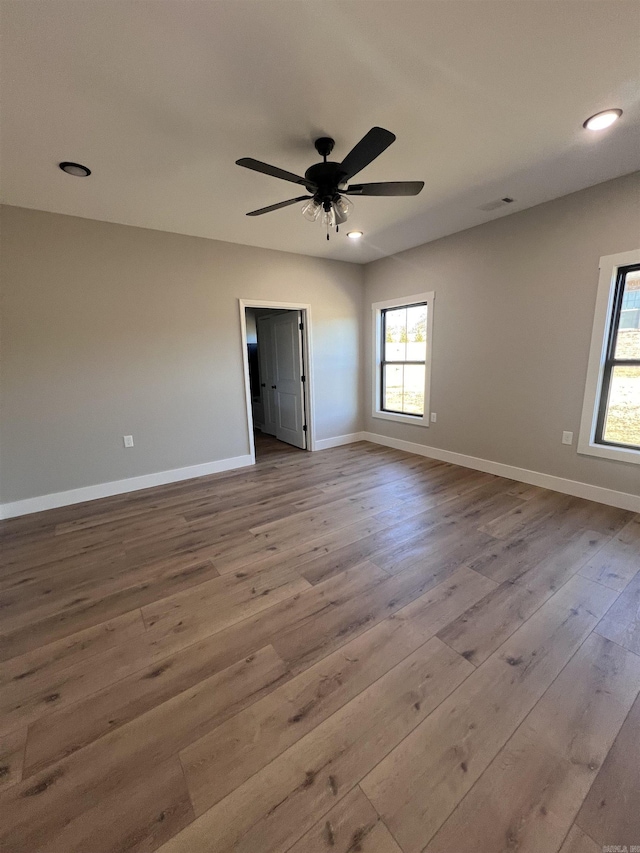 spare room featuring ceiling fan and light hardwood / wood-style floors