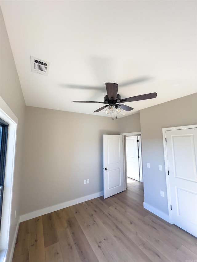 unfurnished bedroom featuring ceiling fan and light wood-type flooring