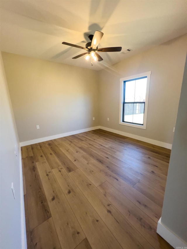 spare room with ceiling fan and wood-type flooring