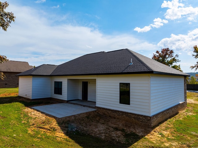 rear view of property featuring a yard and a patio