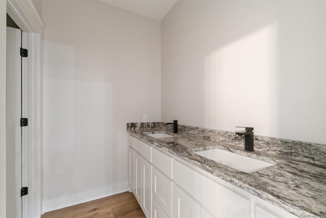 bathroom with vanity and hardwood / wood-style floors