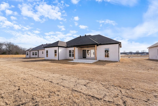 back of house featuring a yard and a patio