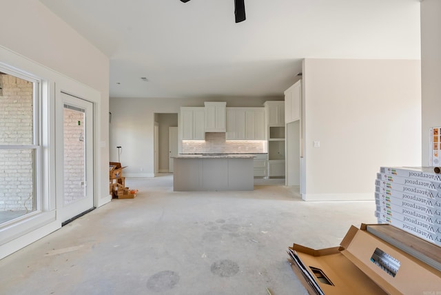 unfurnished living room featuring ceiling fan