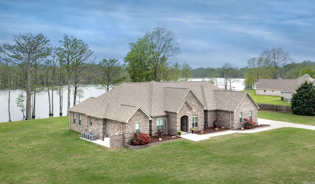 view of front facade featuring a front yard and a water view