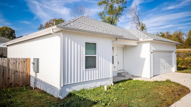 view of side of property with a yard and a garage