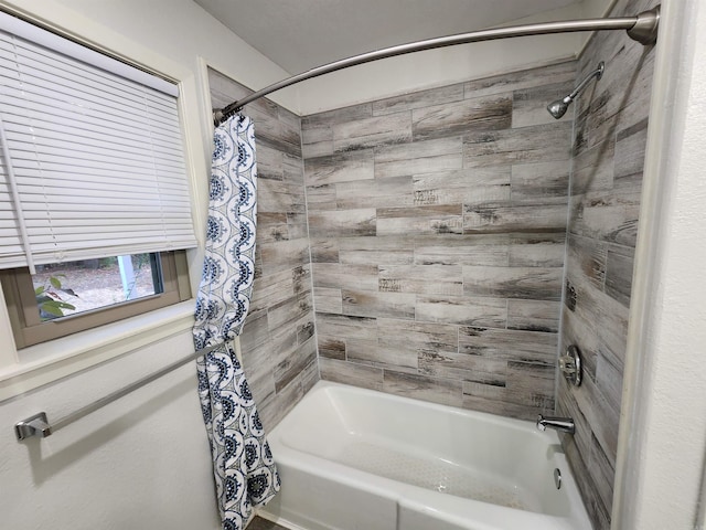 bathroom with shower / bath combo with shower curtain