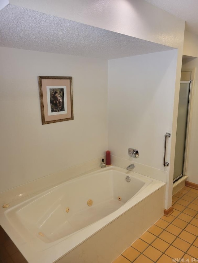 bathroom featuring plus walk in shower, tile patterned flooring, and a textured ceiling