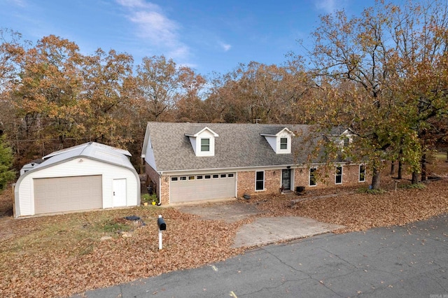 cape cod house featuring a garage