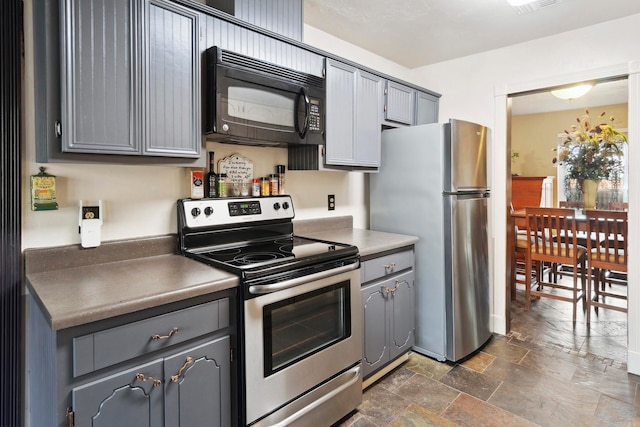 kitchen featuring gray cabinetry and stainless steel appliances