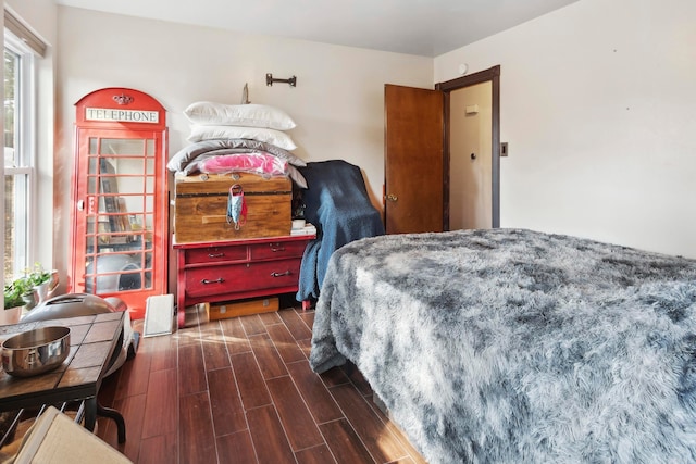 bedroom with dark hardwood / wood-style flooring