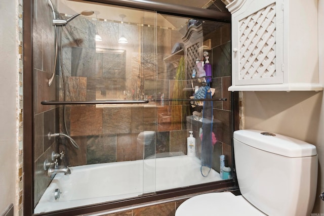 bathroom with shower / bath combination with glass door and toilet