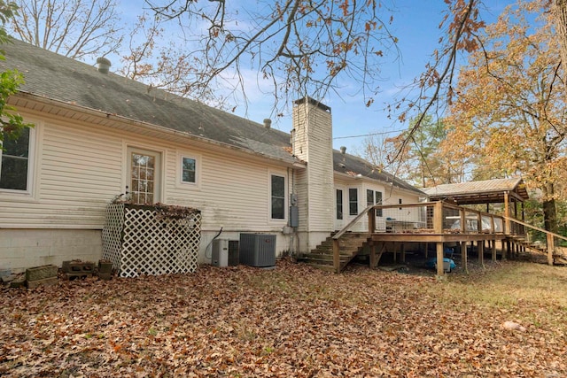 back of property with a deck and central air condition unit