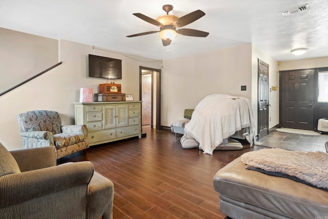 living room featuring wood-type flooring and ceiling fan