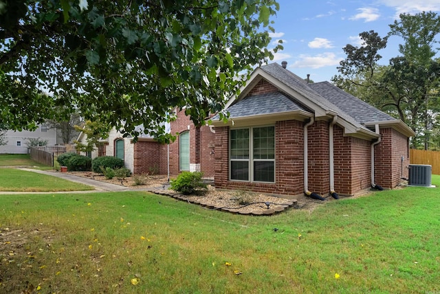 view of front of home with a front lawn and central AC unit