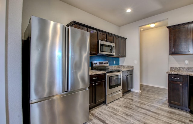 103 Harvest Dr, Beebe, AR 72012 - kitchen featuring stainless steel appliances, dark brown cabinets, light wood-style floors, light stone counters, and recessed lighting