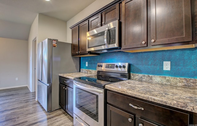 103 Harvest Dr, Beebe, AR 72012 - kitchen featuring appliances with stainless steel finishes, dark brown cabinetry, light wood-type flooring, and baseboards