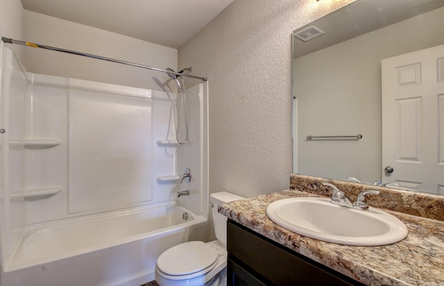 full bathroom featuring vanity, bathtub / shower combination, a textured ceiling, and toilet