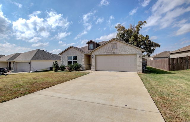 ranch-style house with a garage and a front lawn