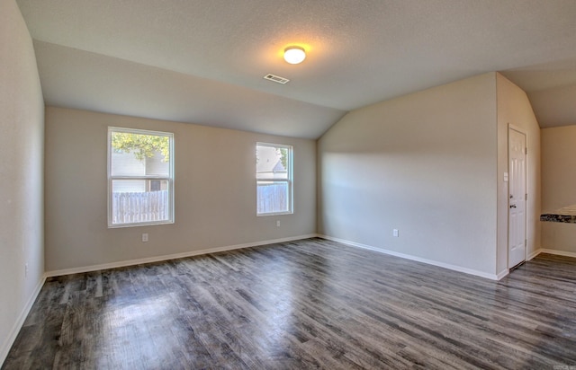 103 Harvest Dr, Beebe, AR 72012 - spare room featuring wood finished floors, lofted ceiling, and baseboards