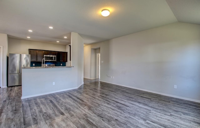 kitchen featuring dark wood-type flooring, appliances with stainless steel finishes, and dark brown cabinetry