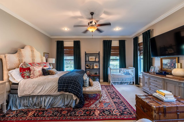 bedroom featuring light carpet, ornamental molding, and ceiling fan