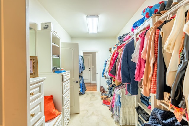 spacious closet featuring light carpet