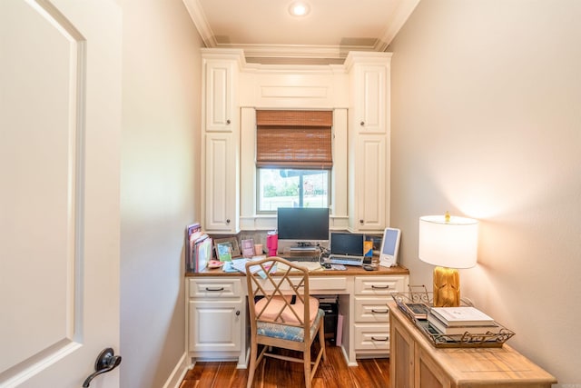 office space with built in desk, crown molding, and dark hardwood / wood-style floors