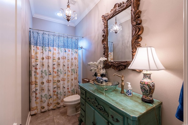 bathroom featuring tile patterned floors, toilet, ornamental molding, vanity, and a chandelier