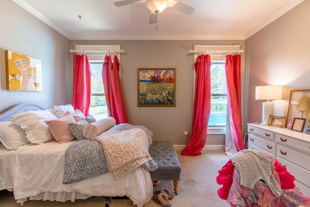 carpeted bedroom featuring ceiling fan and crown molding