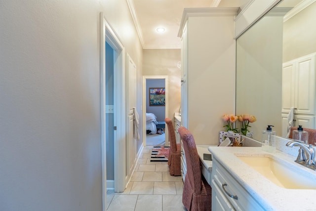 bathroom with vanity, ornamental molding, and tile patterned flooring