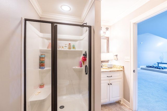 bathroom with vanity, a shower with shower door, and ornamental molding