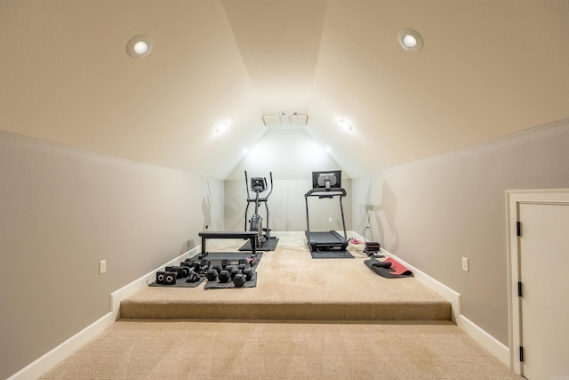 workout area with carpet floors and vaulted ceiling