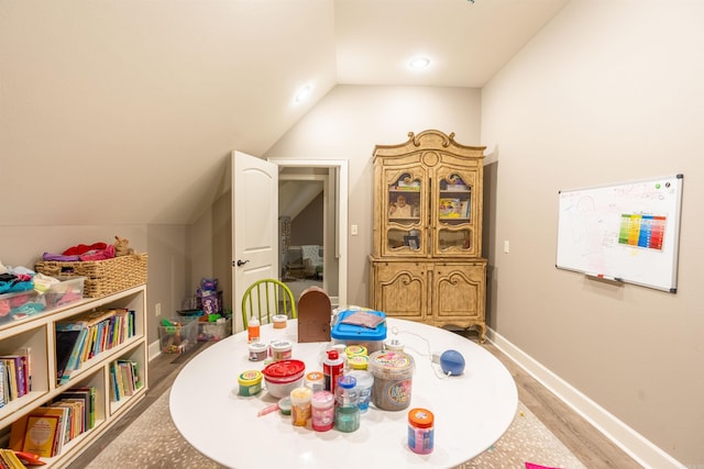 rec room with wood-type flooring and lofted ceiling